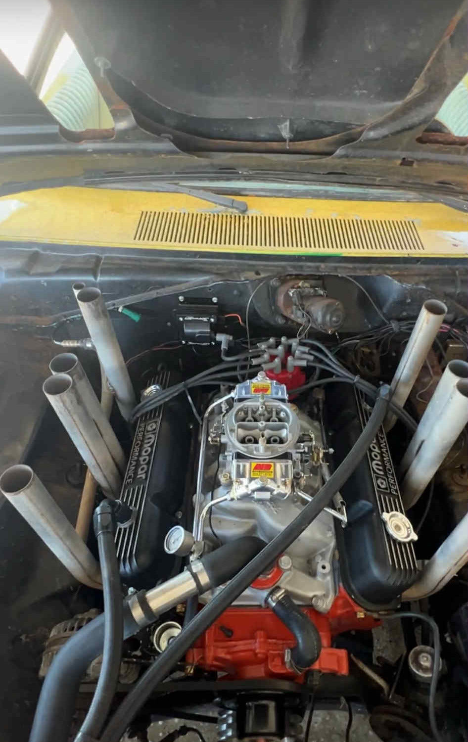 Engine compartment of a vehicle with visible components and wiring.