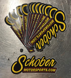 Stack of Schober Motorsports stickers on a metallic surface